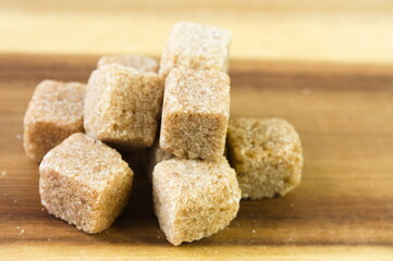 Cube of sugar on wooden table