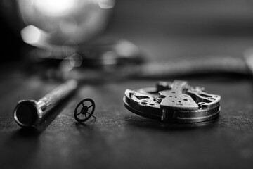 Mechanical watch assembly, watchmaker's workshop with many parts and gears