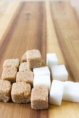 Cube of sugar on wooden table