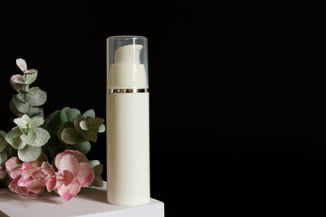white rectangular box with shadows on a black background. White plastic cream jar. For cosmetics or...