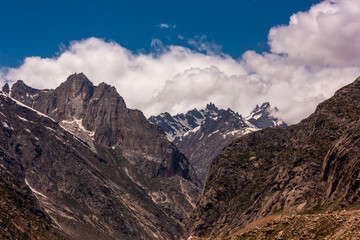 Scenic landscape of high rugged mountains surrounding the high altitude Himalayan pass of Kunzum La in the Spiti valley,