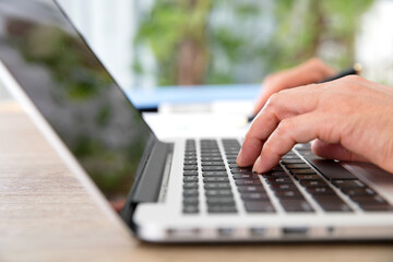 Closeup hand typing on computer keyboard