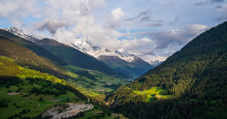 Fototapeta premium Scenic view of beautiful Swiss Alps mountains. Canton du Valais, Switzerland. Picturesque Alpine village in background. Switzerland in summer. Alpine landscape