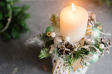Beautiful rustic christmas decoration with candle, ornaments and lights