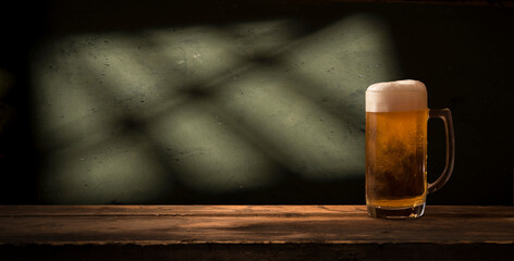 Glass beer on wood background with copyspace