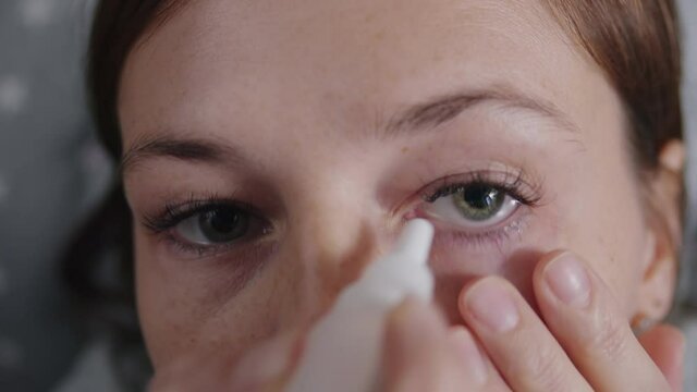 woman applying therapeutic eye drops