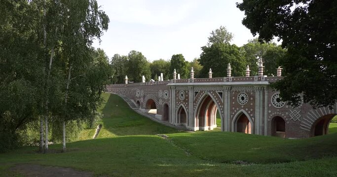 4K high quality sunny spring day video footage of famous Moscow Tsaritsyno Estate built during rein of Czarina Katherine 2 The Great with visitors and panorama of green park in the capital of Russia