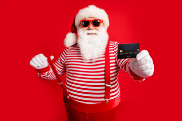 Fototapeta na wymiar Portrait of his he nice handsome cheerful confident bearded fat Santa give you offer bank card payment service spend money budget having fun isolated bright vivid shine vibrant red color background