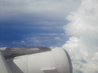 view from airplane window,airplane in the sky, wing of airplane, flight window view of blue sky.