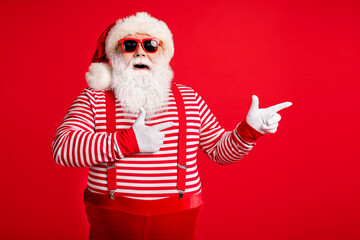 Fototapeta na wymiar Portrait of his he nice handsome attractive glad cheerful bearded fat gray-haired Santa demonstrating copy empty blank place space isolated on bright vivid shine vibrant red color background