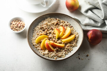Fototapeta na wymiar Healthy oatmeal porridge with fresh peach