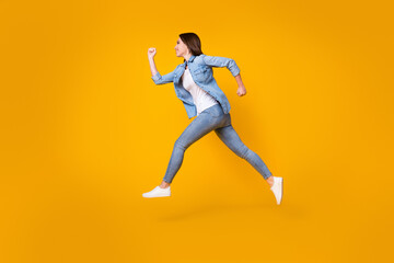 Fototapeta na wymiar Full length body size profile side view of her she nice slim cheerful cheery girl jumping running fast speed active lifestyle regime isolated bright vivid shine vibrant yellow color background