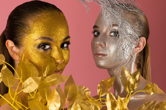 Beautiful Portraits Two Women In Gold And Silver Powder On Pink Background