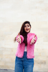 Obraz na płótnie Canvas young cute girl teenager in pink fur coat gesturing hanging around outdoor , lifestyle people concept