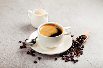 Brewed americano coffee in a white cup with milk