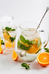 Side view on lemonade in a jug and glass