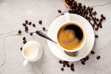 Brewed americano coffee in a white cup with milk