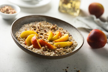 Healthy oatmeal porridge with fresh peach
