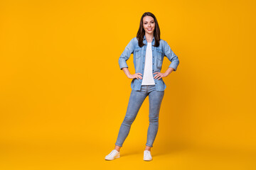 Fototapeta na wymiar Full length photo of attractive pretty confident lady arms by sides good mood adorable appearance nice day wear casual denim shirt shoes isolated vibrant yellow color background