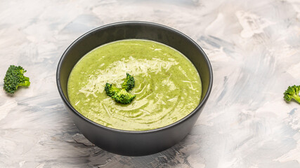 Fresh healthy green soup with parmesan cheese. Food recipe background. Close up