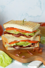 Double bacon sandwich on wooden plate