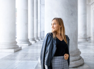 The portrait of a blonde teen girl walking in the city, visit a museum