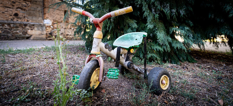 Old abandoned and rusty tricycle closeup view