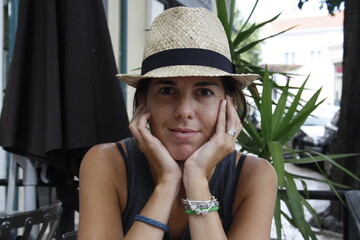 young girl with hat in Porto cafe