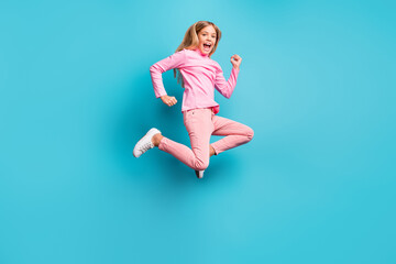 Fototapeta na wymiar Full size photo of cool amazed pretty teen girl jump air wear pink pants poloneck white footwear isolated on bright teal background