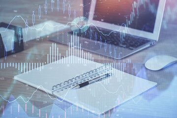 Double exposure of chart and financial info and work space with computer background. Concept of...
