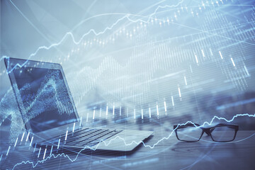 Stock market graph and table with computer background. Double exposure. Concept of financial analysis.