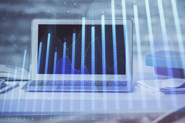 Stock market chart hologram drawn on personal computer background. Multi exposure. Concept of investment.