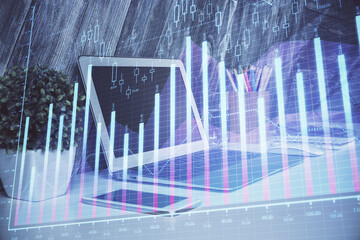 Financial graph colorful drawing and table with computer on background. Double exposure. Concept of...