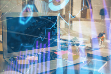 Financial chart drawing and table with computer on background. Double exposure. Concept of international markets.