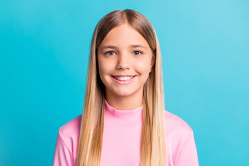 Photo portrait of pretty schoolgirl with blonde hair smiling isolated on bright teal color background