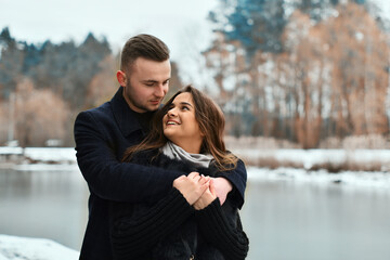 The concept of romance and love. Winter love story of a couple in love. smile, hugs and kiss