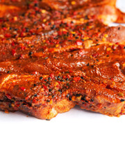 Slices of pork belly marinated with spicy red sous and herb on a white isolated, Meat industry product