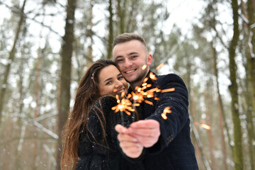 smile, hugs and kiss of a couple in love. New Year's light. Winter love story. romance and love