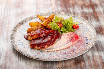 Grilled chicken fillet in barbecue sauce with baked potatoes and garlic sauce