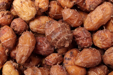 Pile of raw tiger nuts or chufa as background, top view, close up.