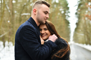 Fototapeta premium hugs of a couple in love. Winter love story