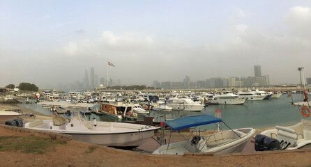 Abu Dhabi city view in a foggy day with a lot of boat