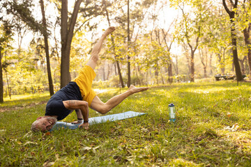 Fit male doing balance asana in nature