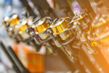 fishing rods with coils of different sizes on the counter in the fishing shop