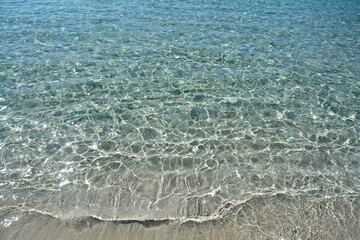 The crystalline waters of the Mediterranean sea in Sicily with intense turquoise and blue...