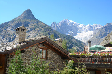 Alpine panorama in Courmayeur in the Aosta Valley with the Mont Blanc massif and glacier and the Mont Chetif peak.