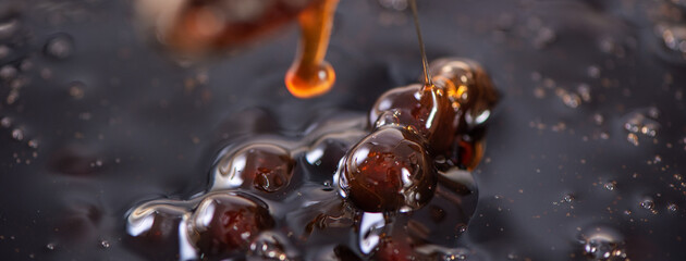 Cooking brown sugar flavored tapioca pearl balls with a scoop.