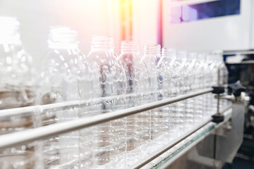 PET plastic bottles on a food automated line, milk and yoghurt bottling industry in dairy factory