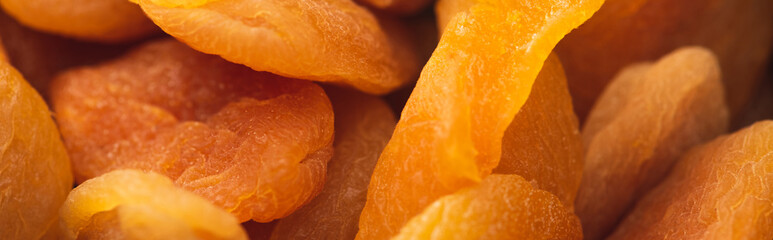closeup of delicious dried apricots background, banner