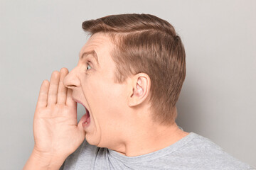 Portrait of man shouting in full voice and calling someone